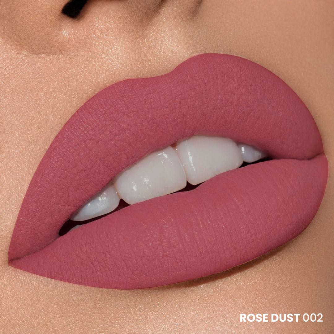 A close-up of a pair of lips painted with matte red lipstick, against a neutral background.